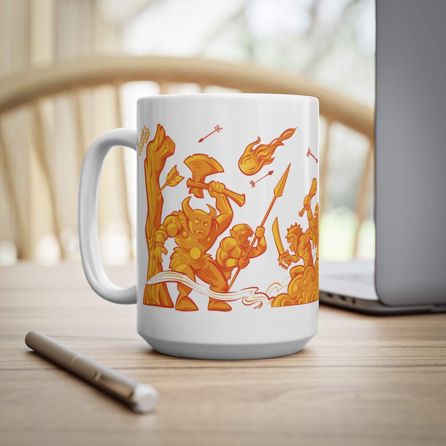 White mug with orange warrior design on a wooden surface