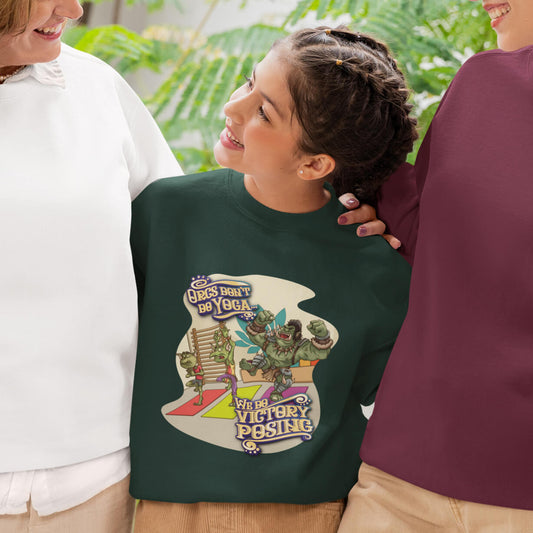 girl wearing a green sweatshirt with a colorful graphic design of an Orc attempting yoga