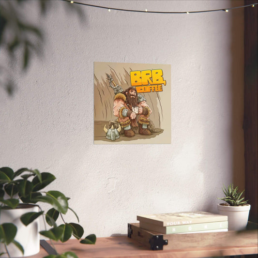 Funny barbarian coffee poster shown on a wall: a fur-clad warrior resting in a cave with a steaming mug, 'BRB, Coffee'.