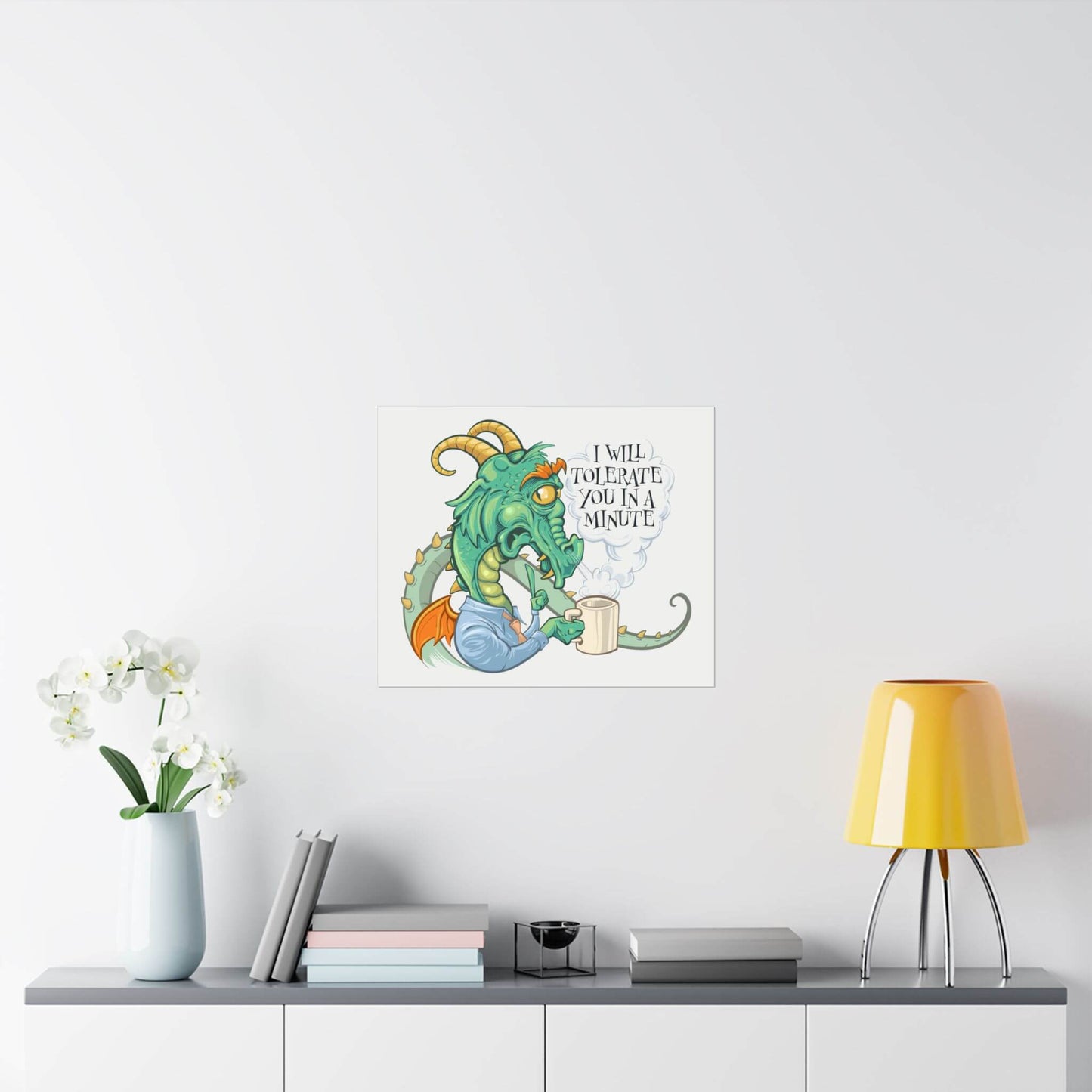 Funny grumpy coffee dragon poster shown on a wall: a horned dragon grumbling over a mug, 'I Will Tolerate You in a Minute'.