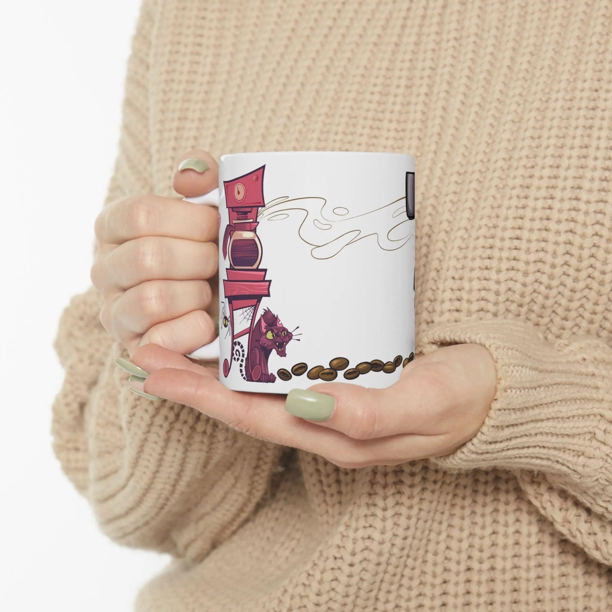Person holding a mug with a coffee-themed design against a beige background