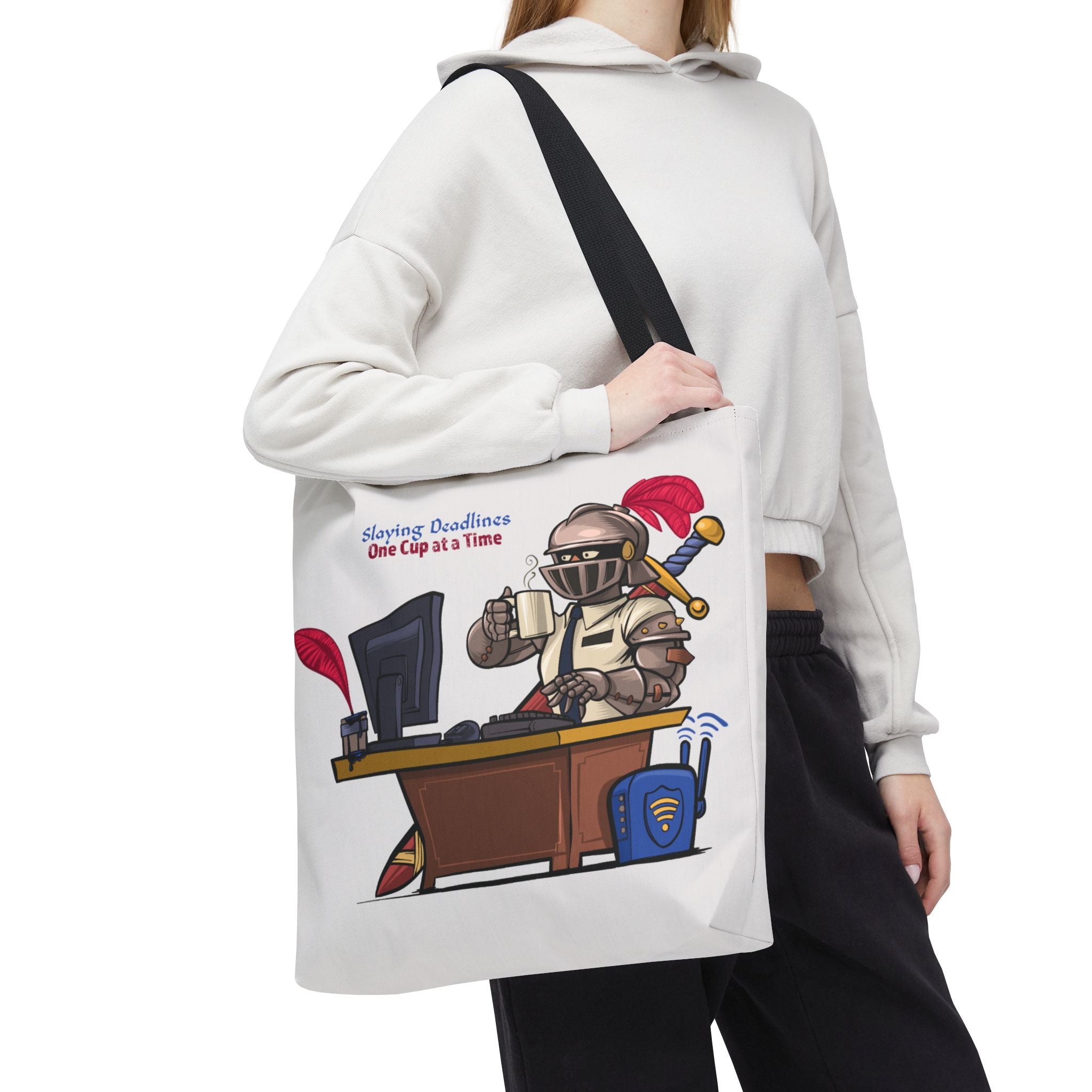 Person holding a tote bag with a cartoon character at a desk and text.