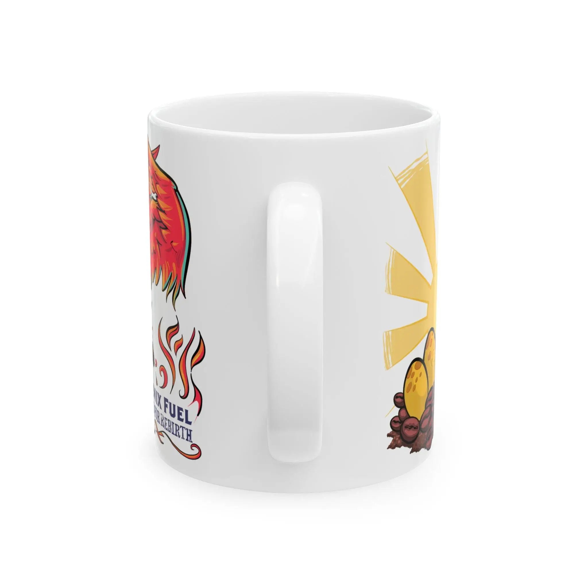 Back view of the Phoenix Fuel mug showing the white ceramic handle. On either side, part of the playful fantasy design is visible—featuring a hatching phoenix chick among coffee beans and fiery feathers with text reading “Phoenix Fuel: Brewed for Rebirth.”