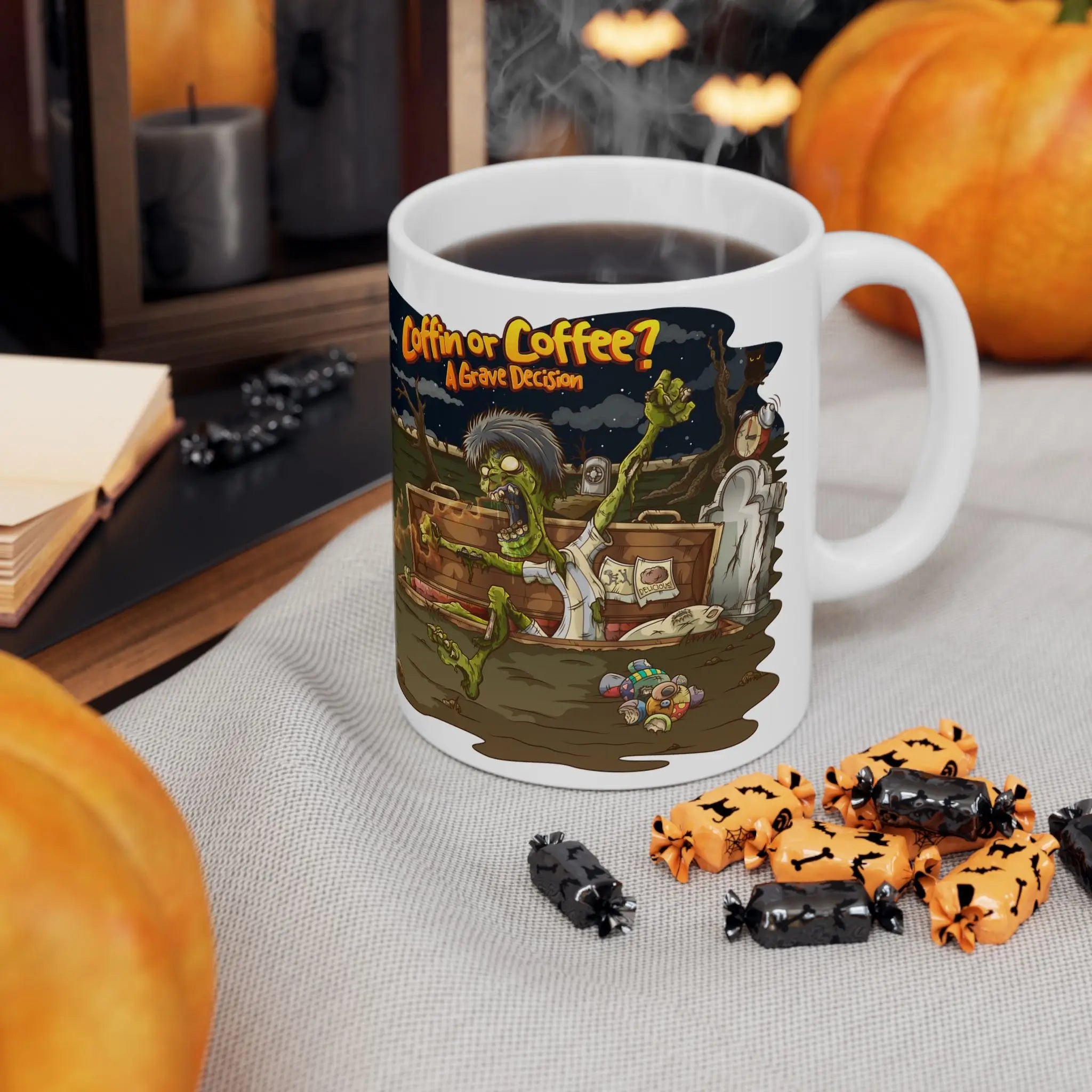 Halloween-themed mug with a design of a zombie and candy, surrounded by pumpkins and treats on a table.