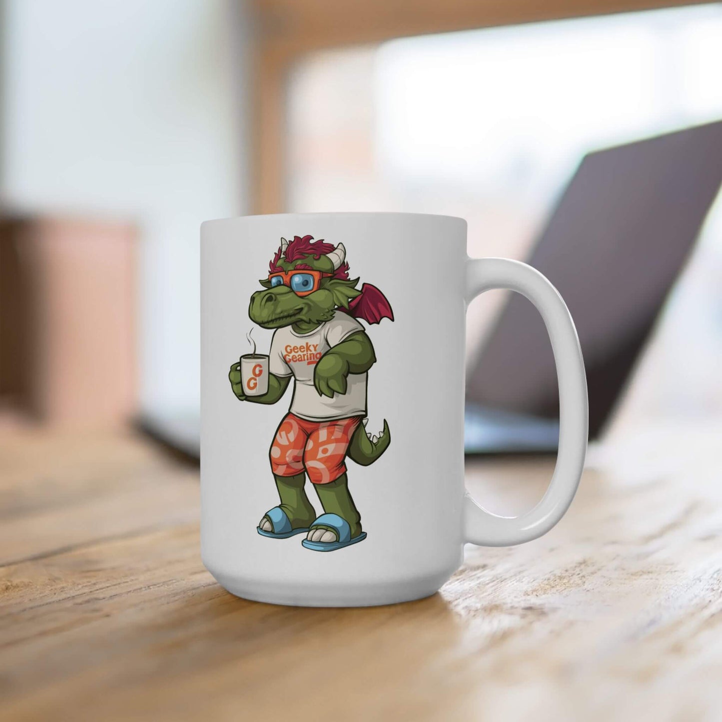 White mug with a cartoon dragon with glasses design holding a coffee cup on a wooden surface.