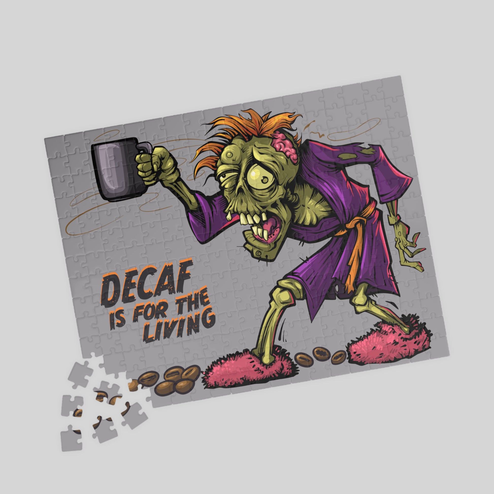 Jigsaw puzzle with a cartoon zombie character holding a mug, labeled 'Decaf is for the Living', on a light gray background.
