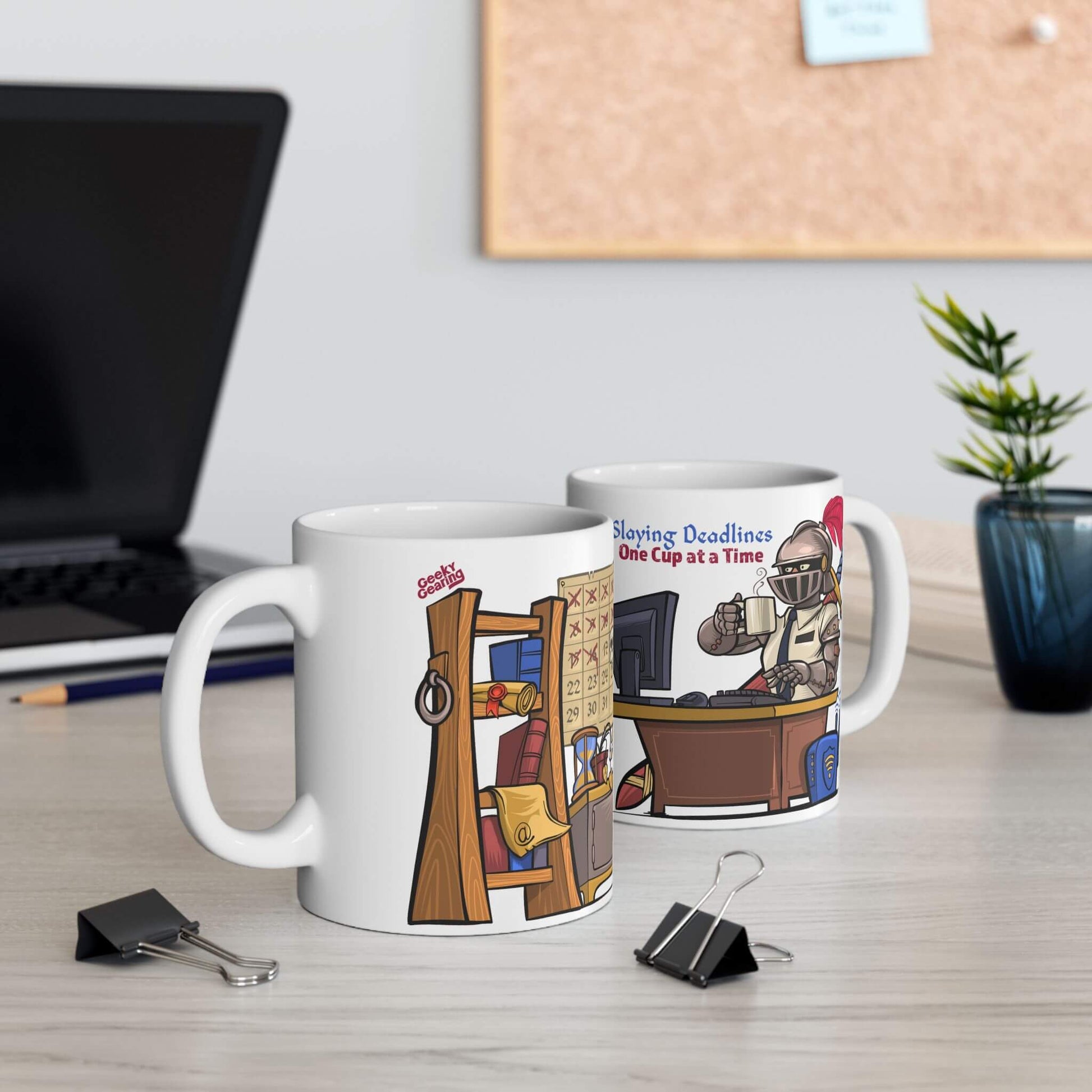 Two mugs with illustrated designs on a desk with office supplies and a plant.
