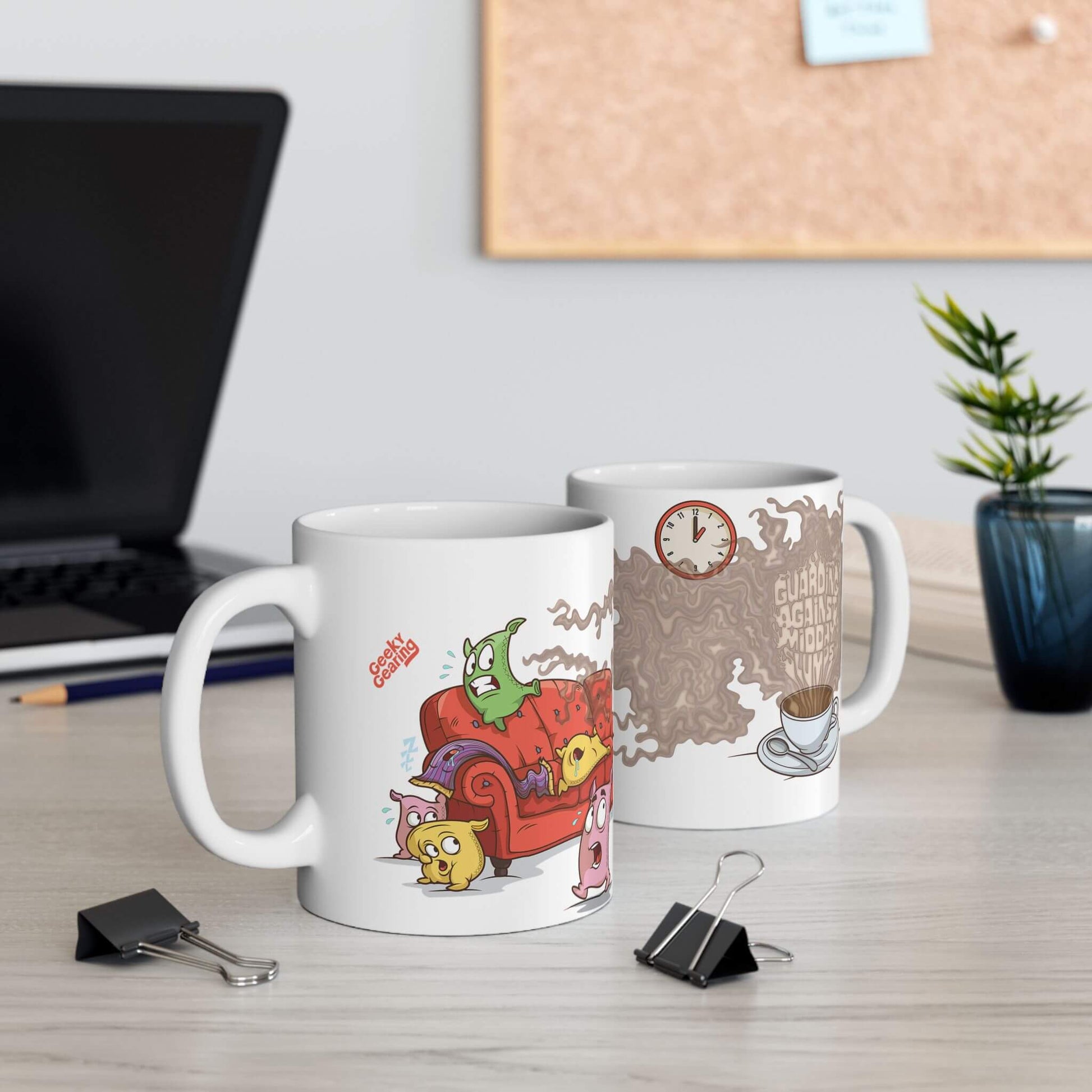 Two mugs on a desk with cartoon designs, a laptop, and office supplies in the background.