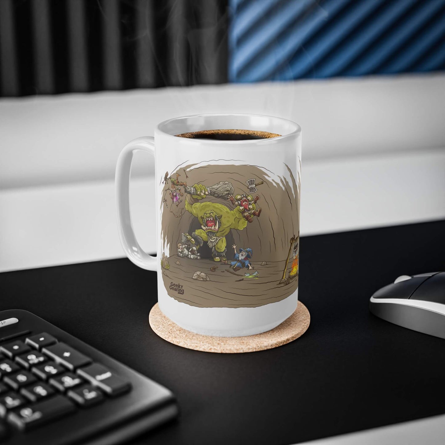 Mug with a cartoon design of a monster fighting adventures in a cave on a desk with a keyboard and mouse