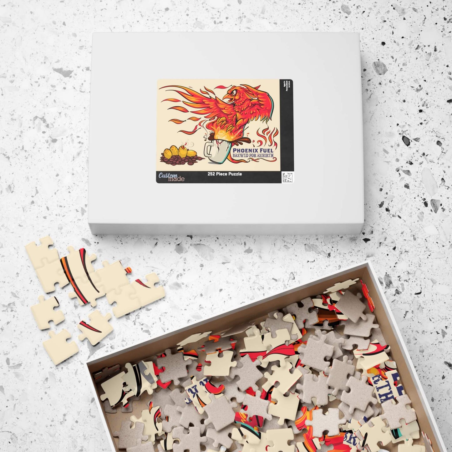 Puzzle with pieces and packaging on a textured surface