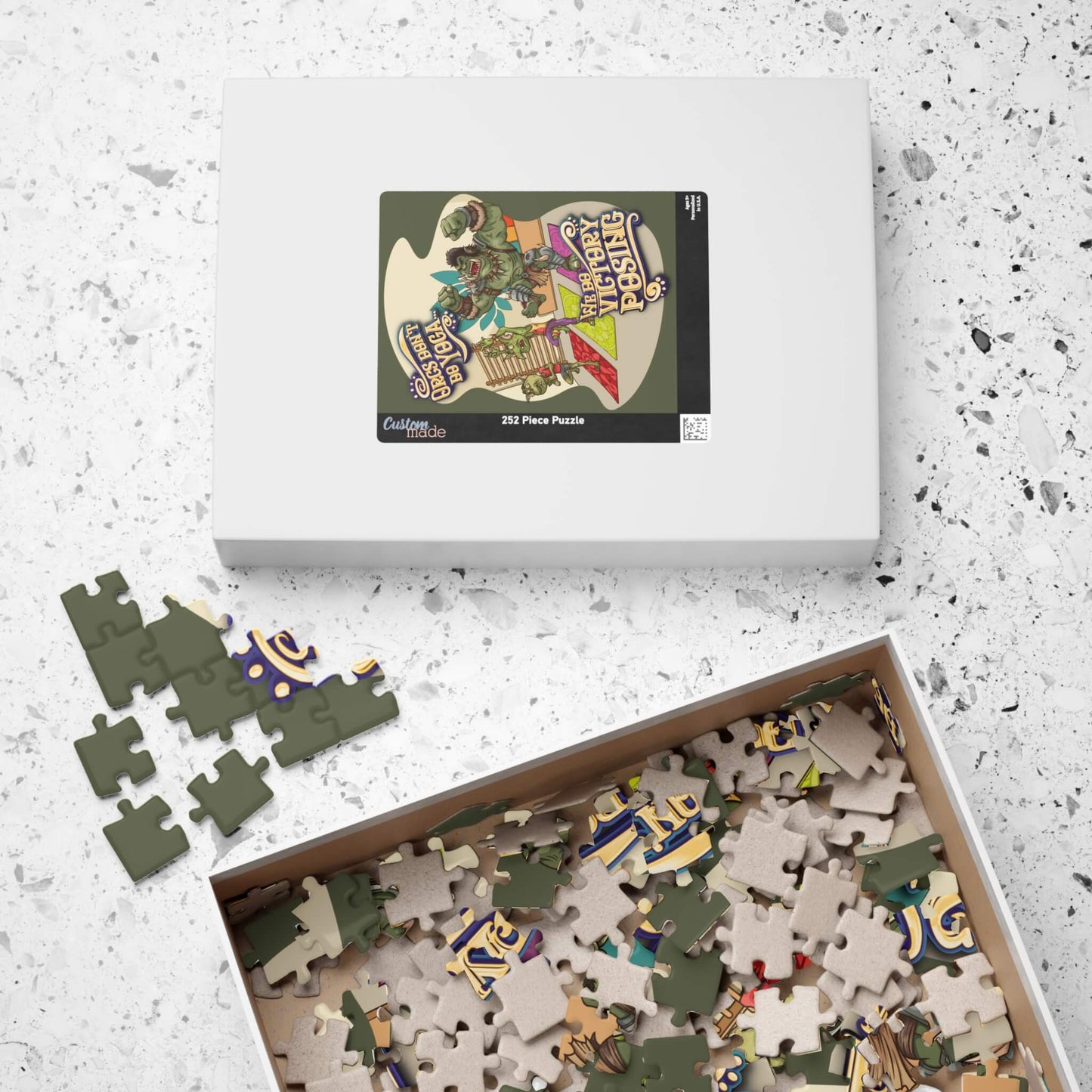 Puzzle set with pieces and packaging on a textured surface