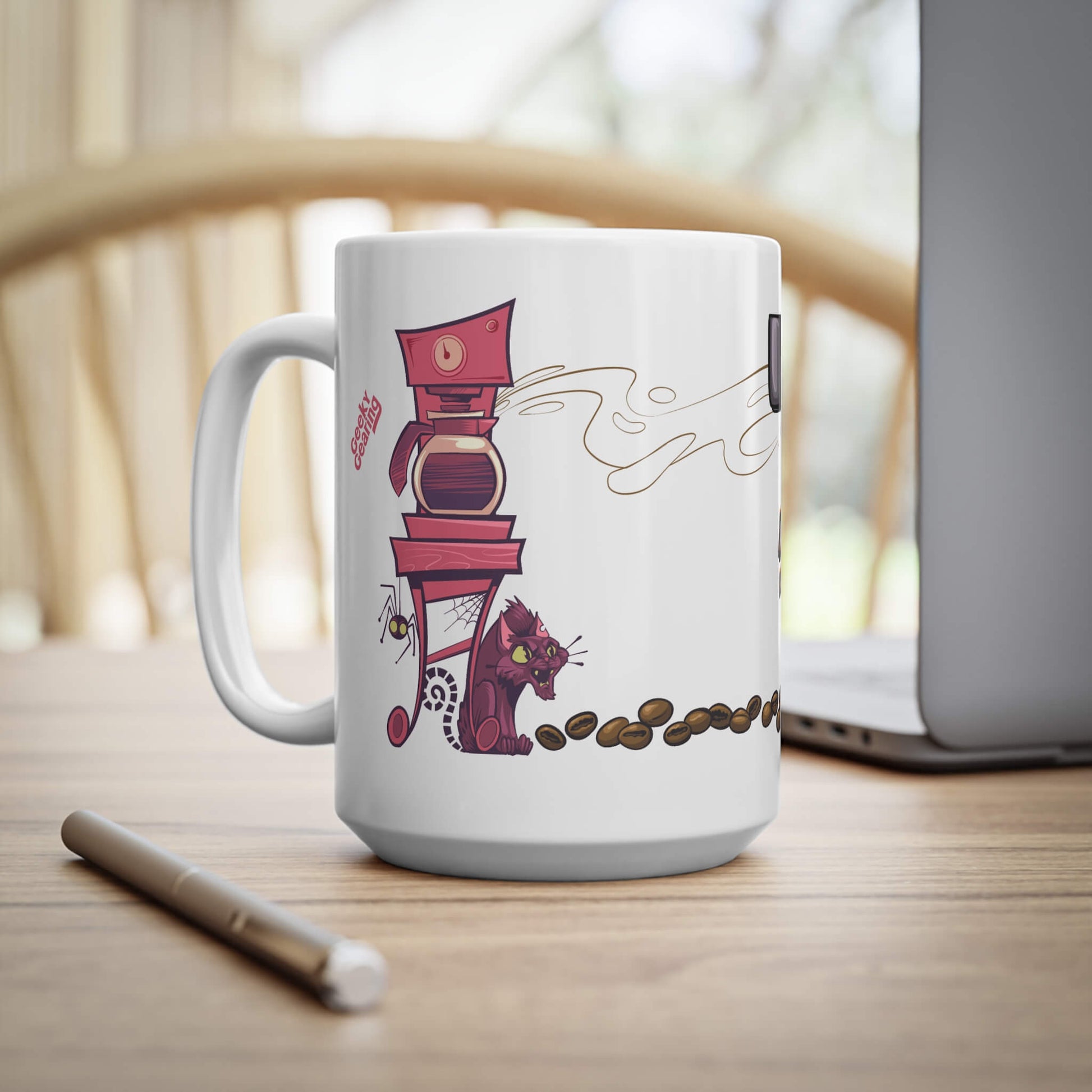 White mug with a cartoon design of a red red besides a coffee maker on a wooden table.