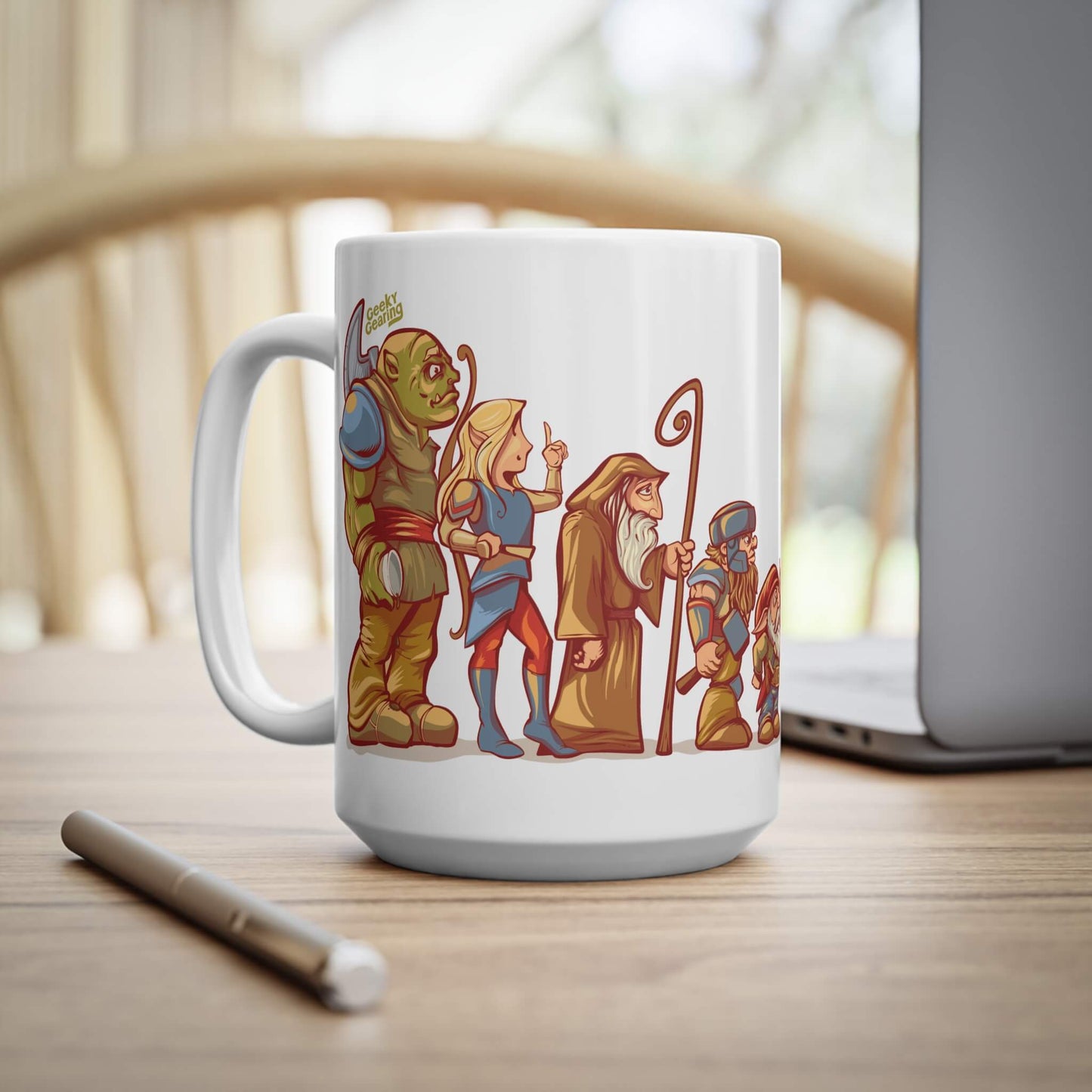 White mug with illustrated fantasy characters on a wooden surface
