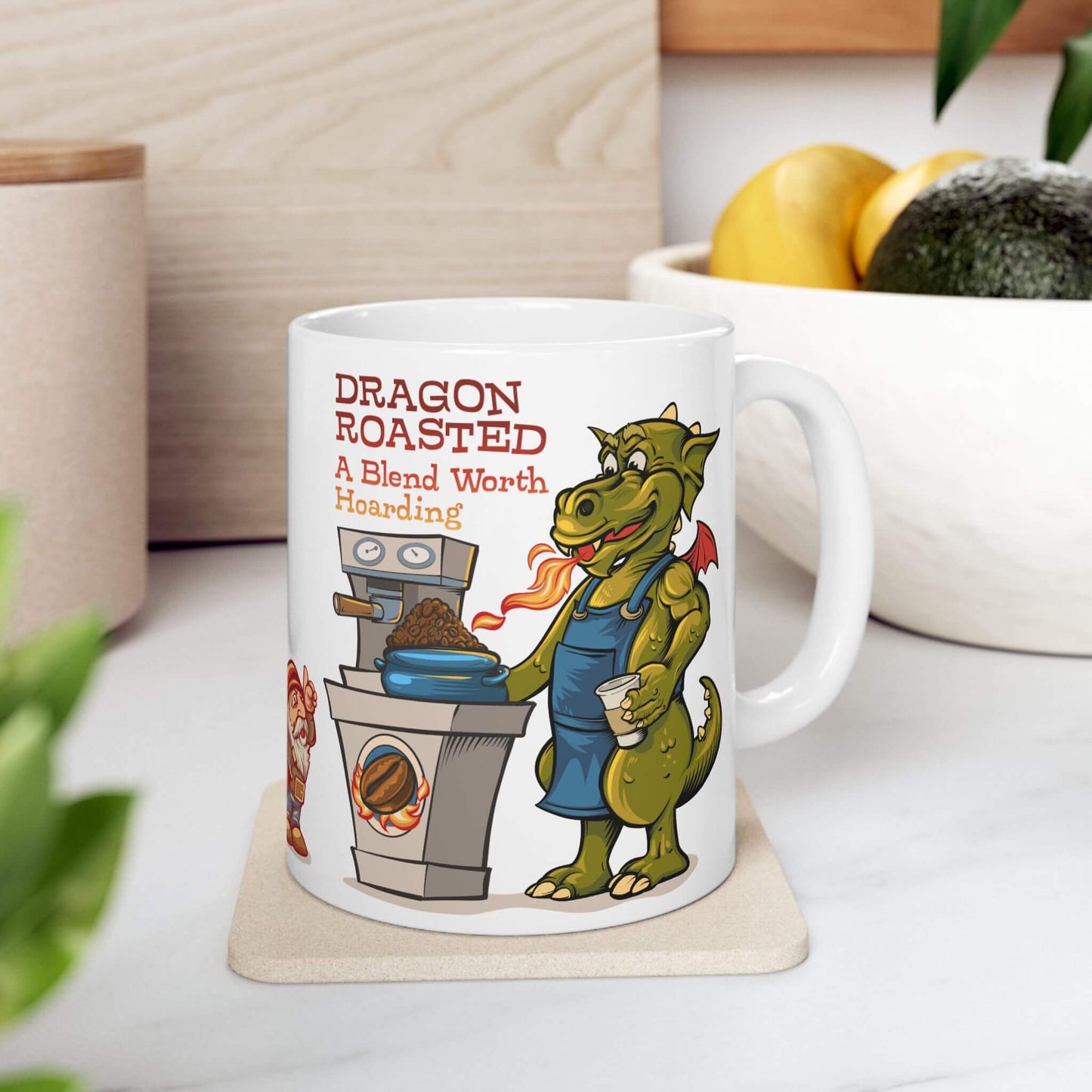Mug with a dragon roasting coffee design on a table with a plant and container in the background.