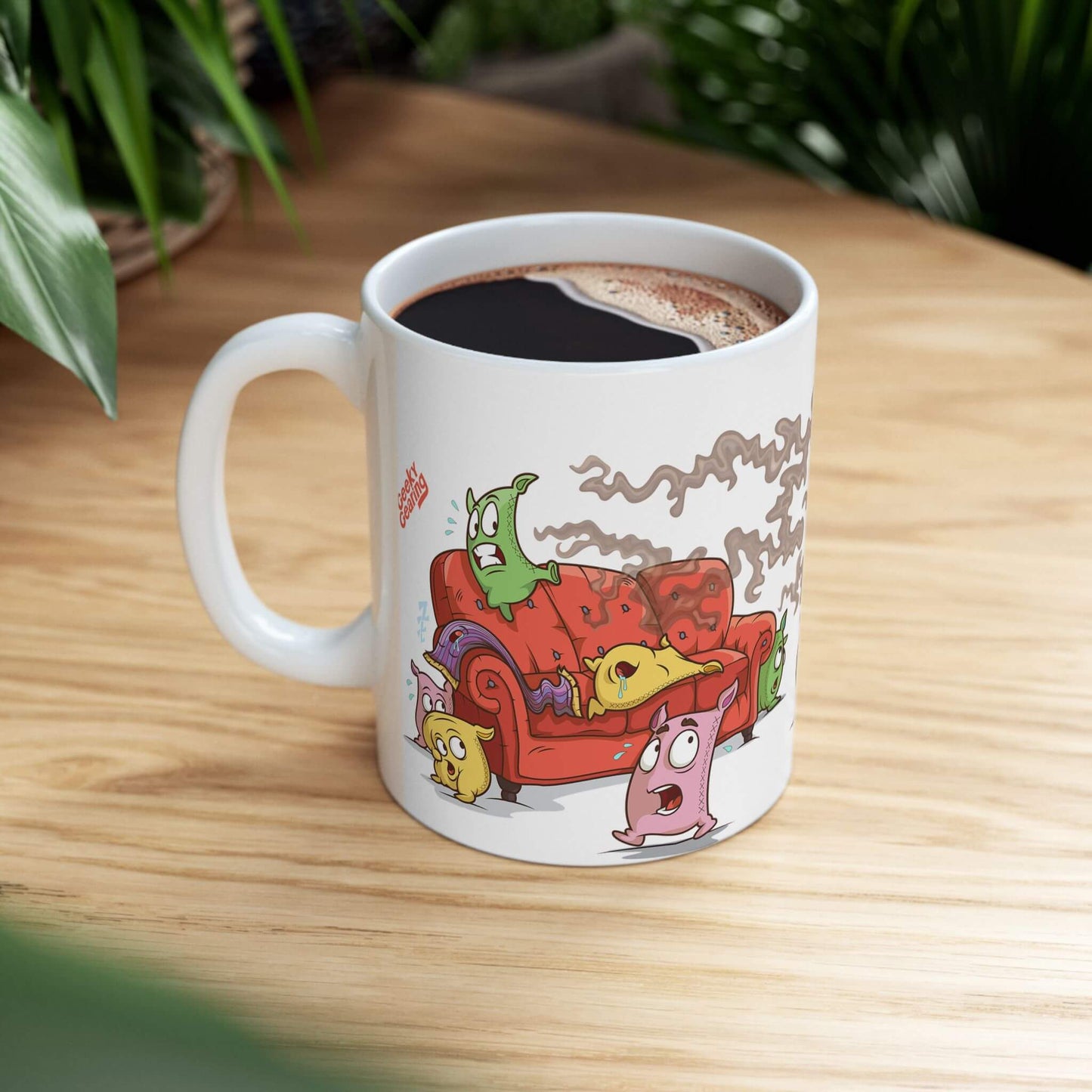 Mug with cartoon pillow and blanket characters on a wooden table