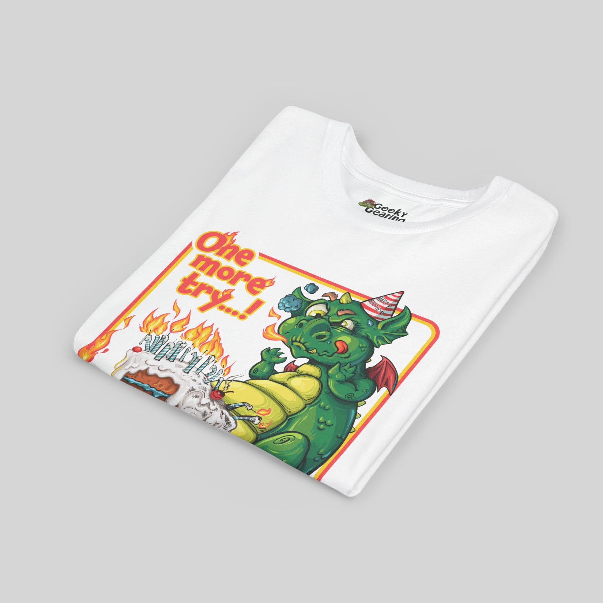 Folded white t-shirt with a colorful graphic of a dragon and text on a gray background