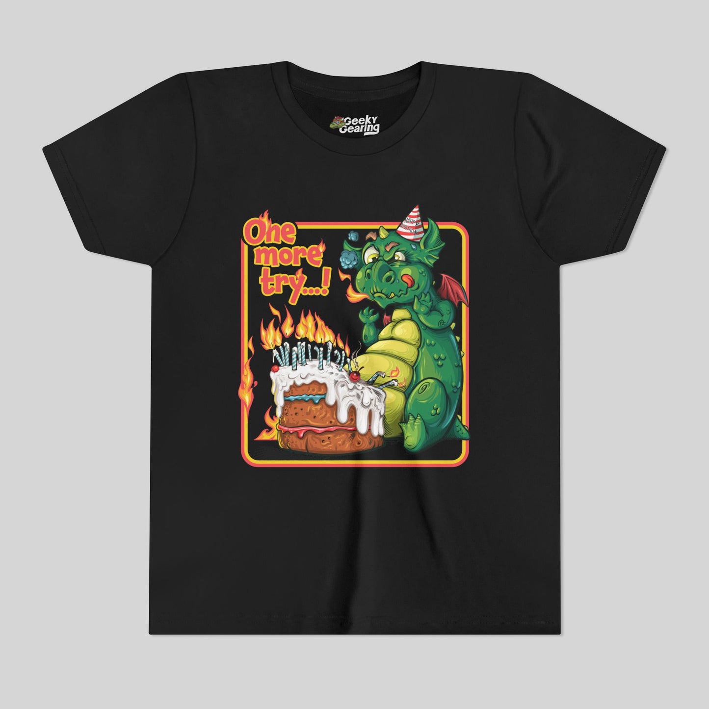 Black t-shirt with a dragon and birthday cake graphic on a gray background