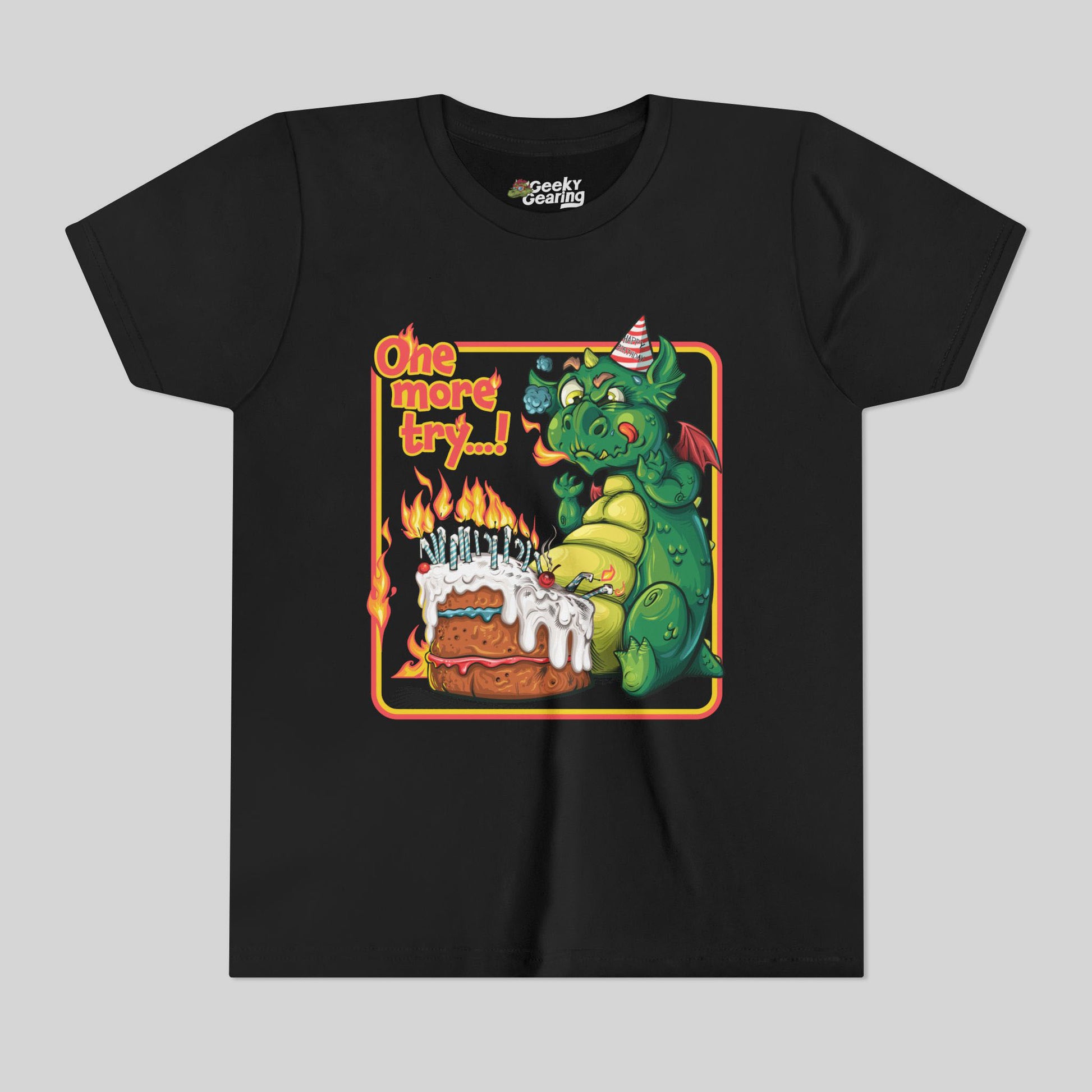 Black t-shirt with a dragon and birthday cake graphic on a gray background