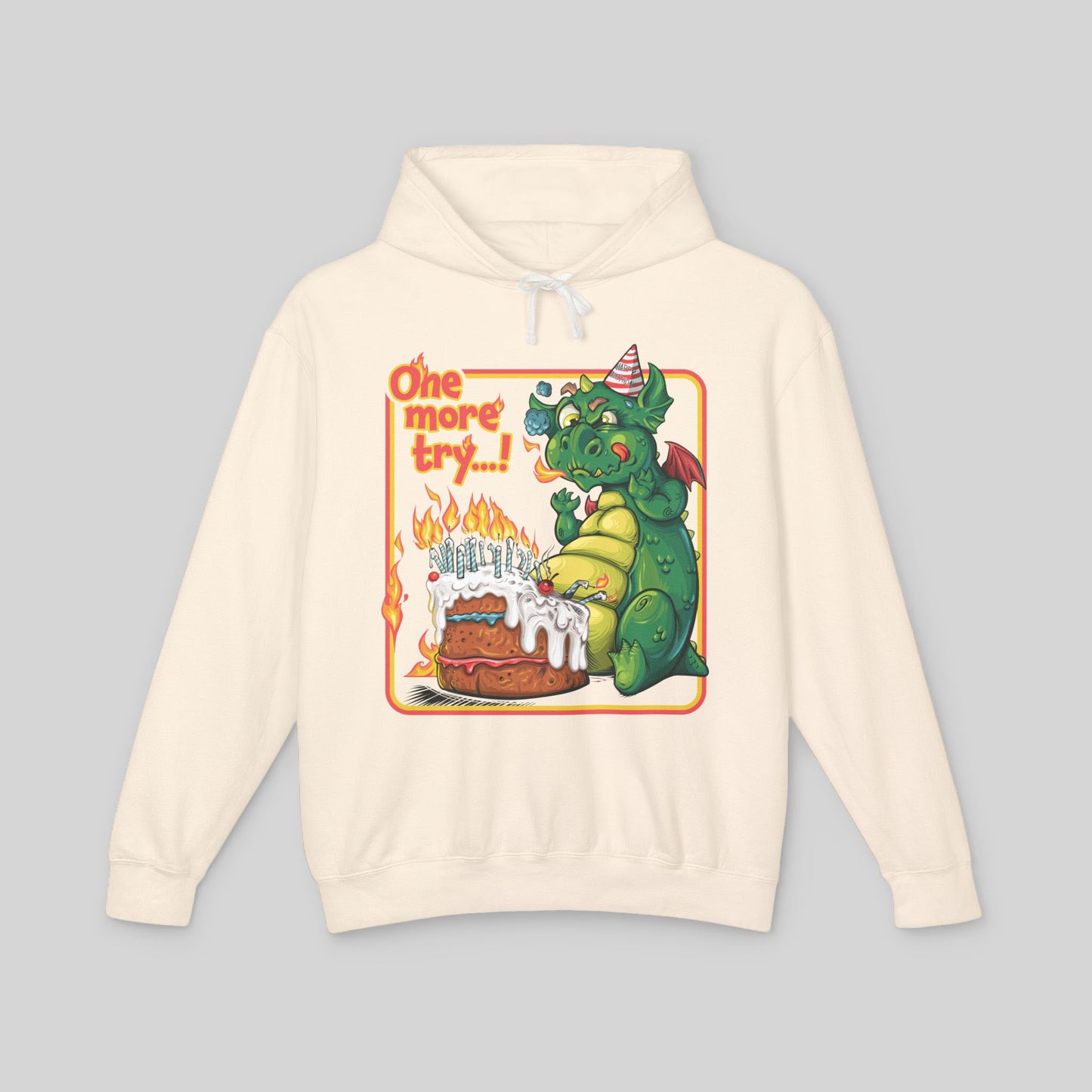 Beige hoodie with a cartoon dragon and birthday cake design on a gray background
