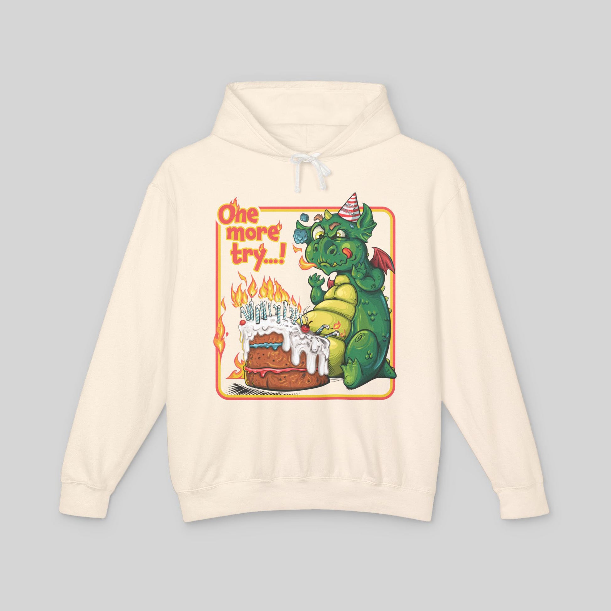Beige hoodie with a cartoon dragon and birthday cake design on a gray background