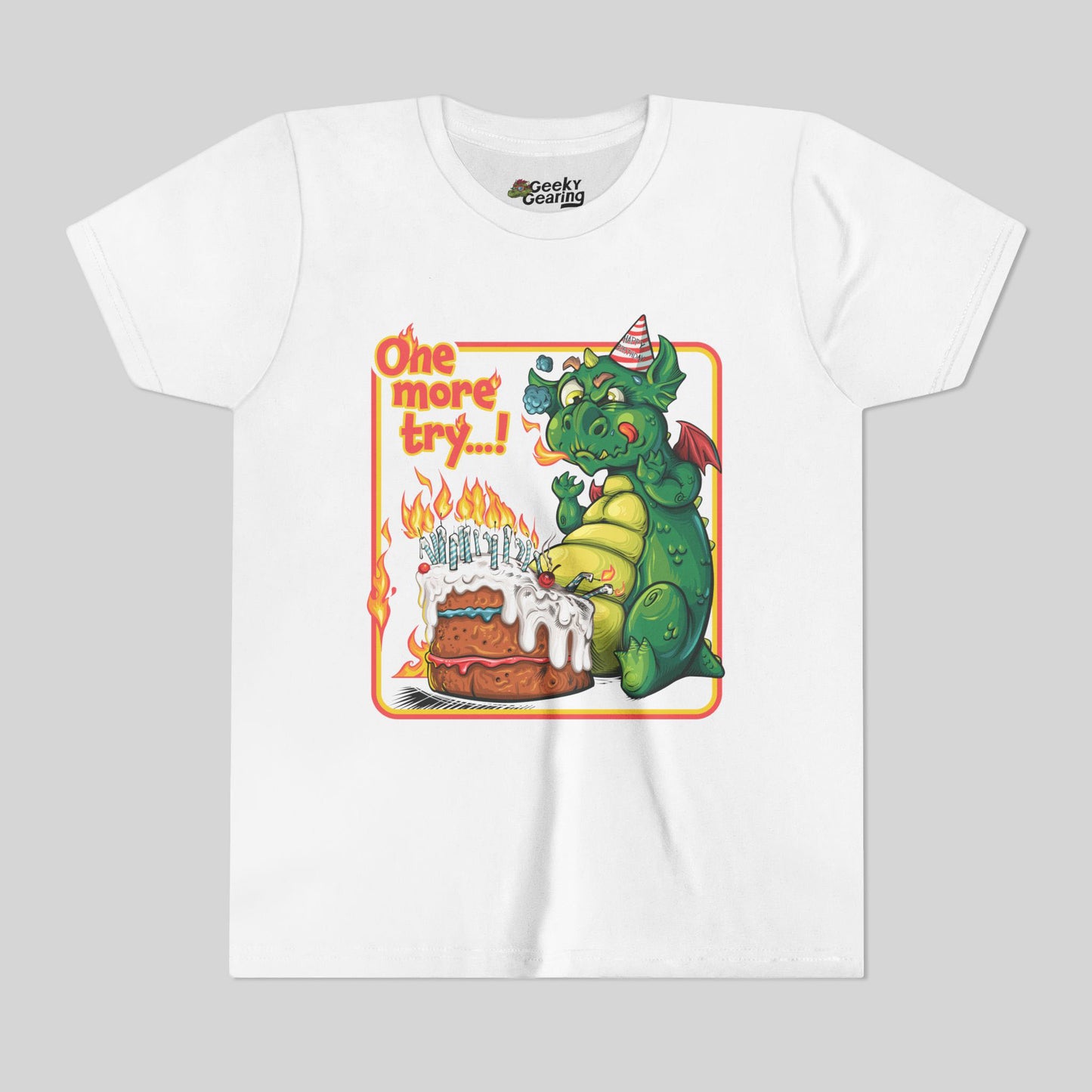 White t-shirt with a cartoon dragon celebrating his birthday with a big cake