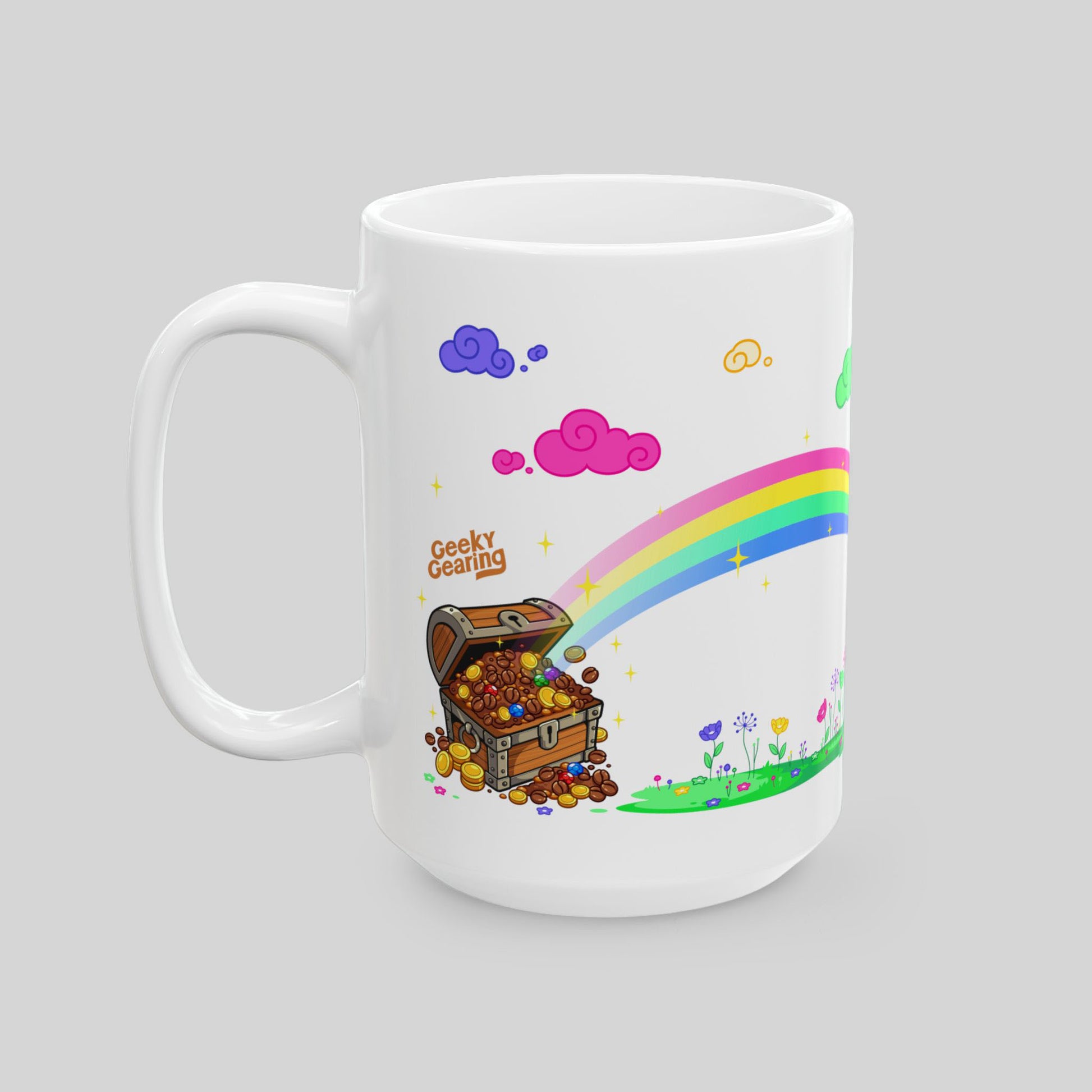 White mug with colorful design featuring a treasure chest, rainbow, and cartoon elements on a gray background.