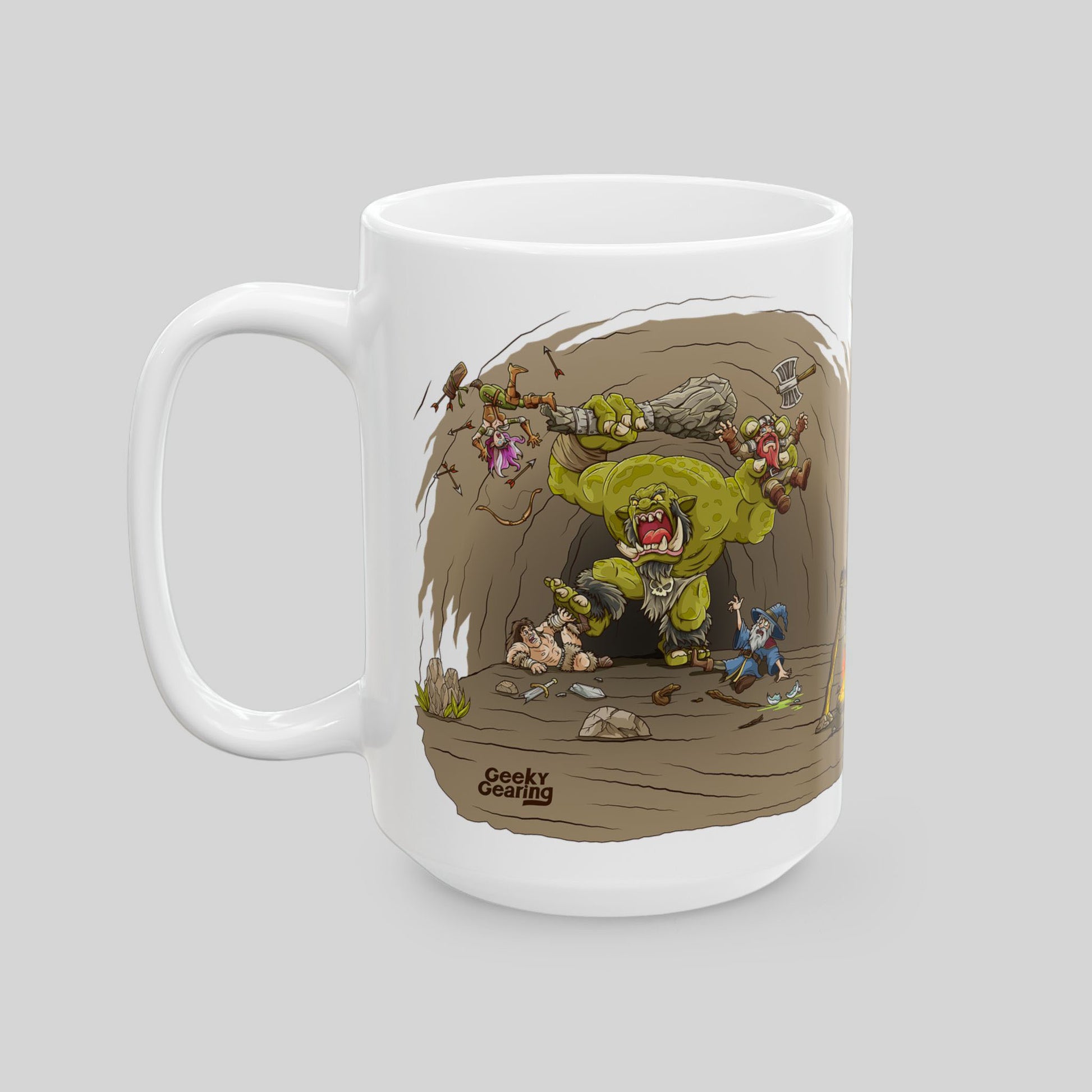 White mug with a cartoon design of a monster fighting characters on a gray background