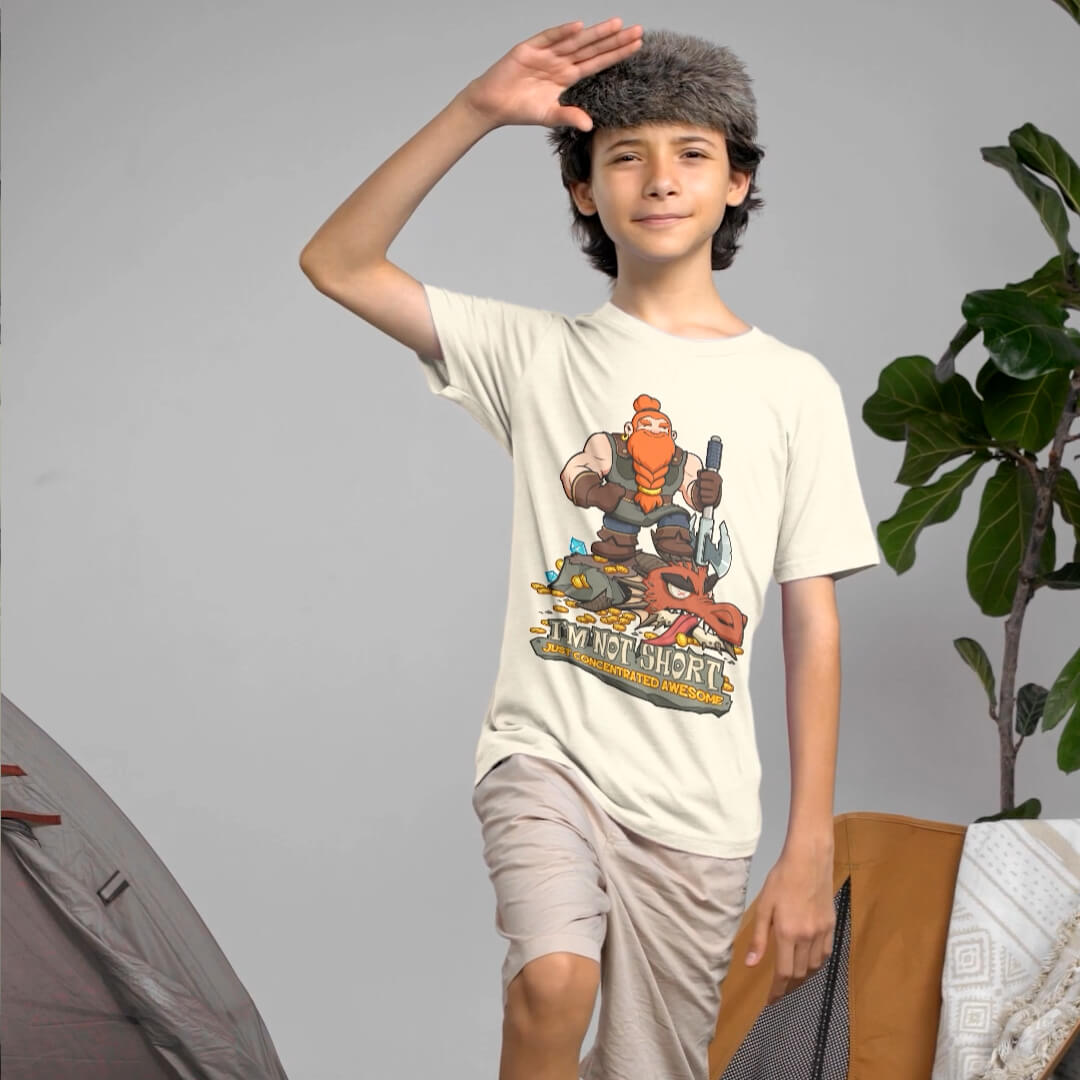 Child wearing a t-shirt with a cartoon character design, standing indoors.
