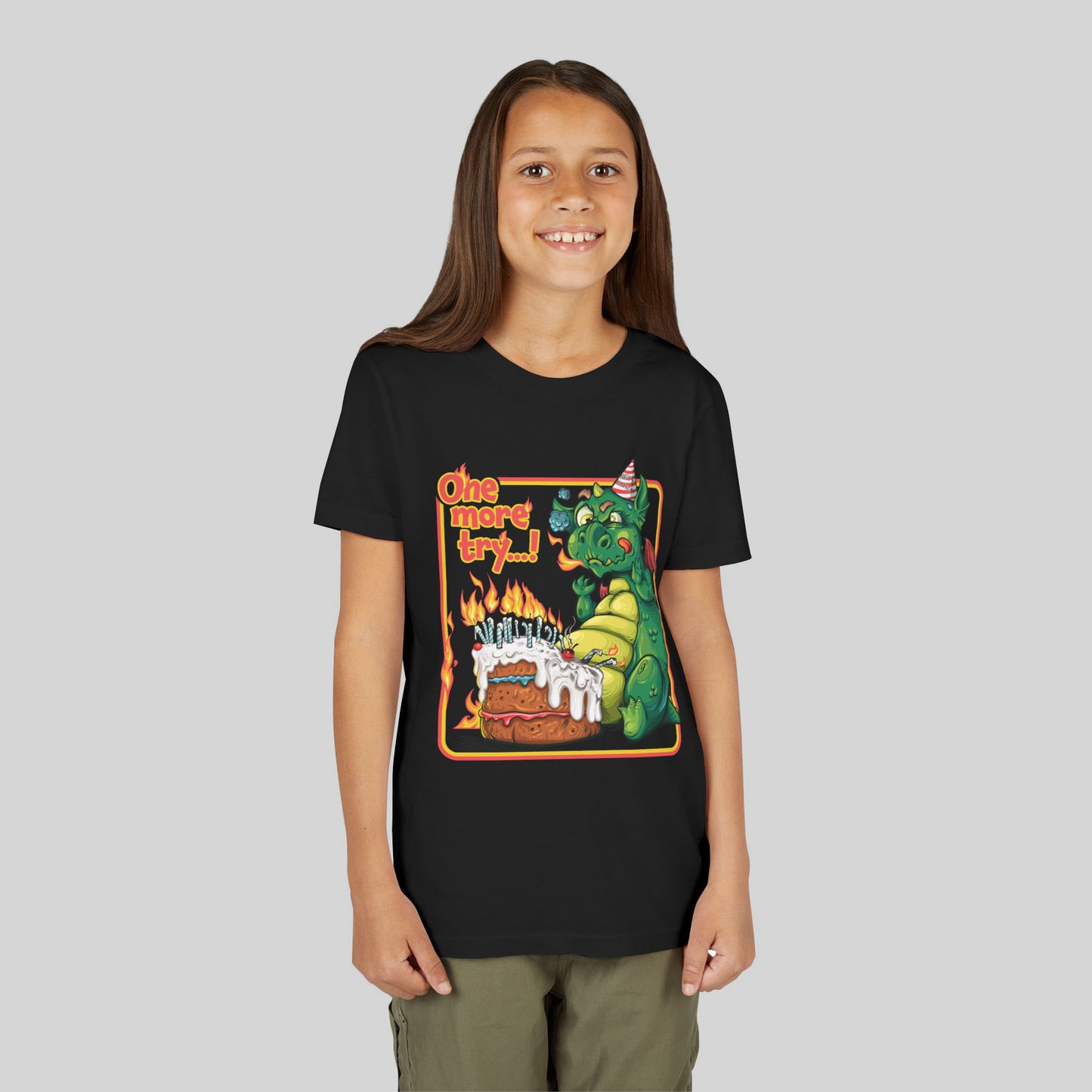 Child wearing a black t-shirt with a colorful dragon celebrating his birthday design on a plain background