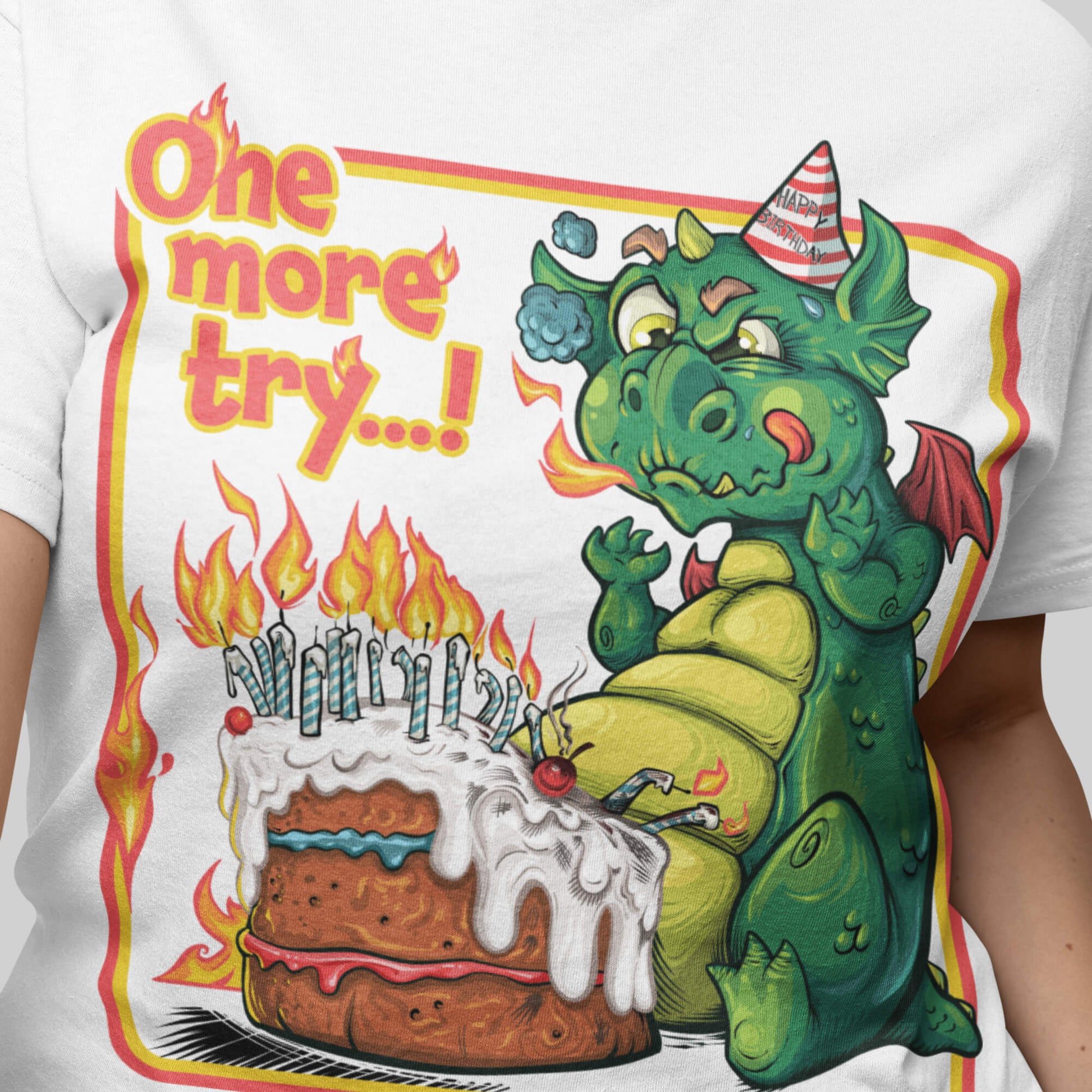 T-shirt with a green dragon and birthday cake graphic and text 'One more try...!'.