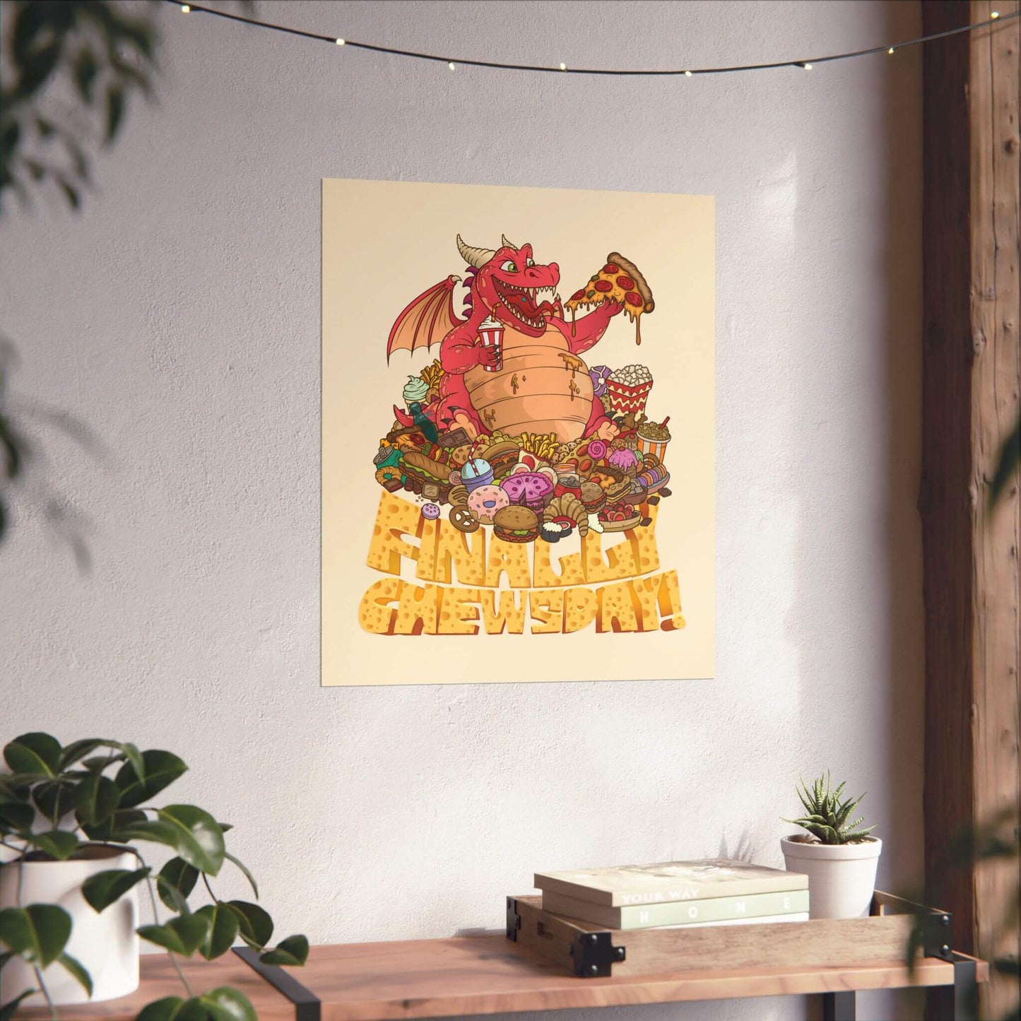 Funny junk food dragon poster shown on a wall: a round dragon perched on a mountain of treats, 'Finally Chewsday!'.