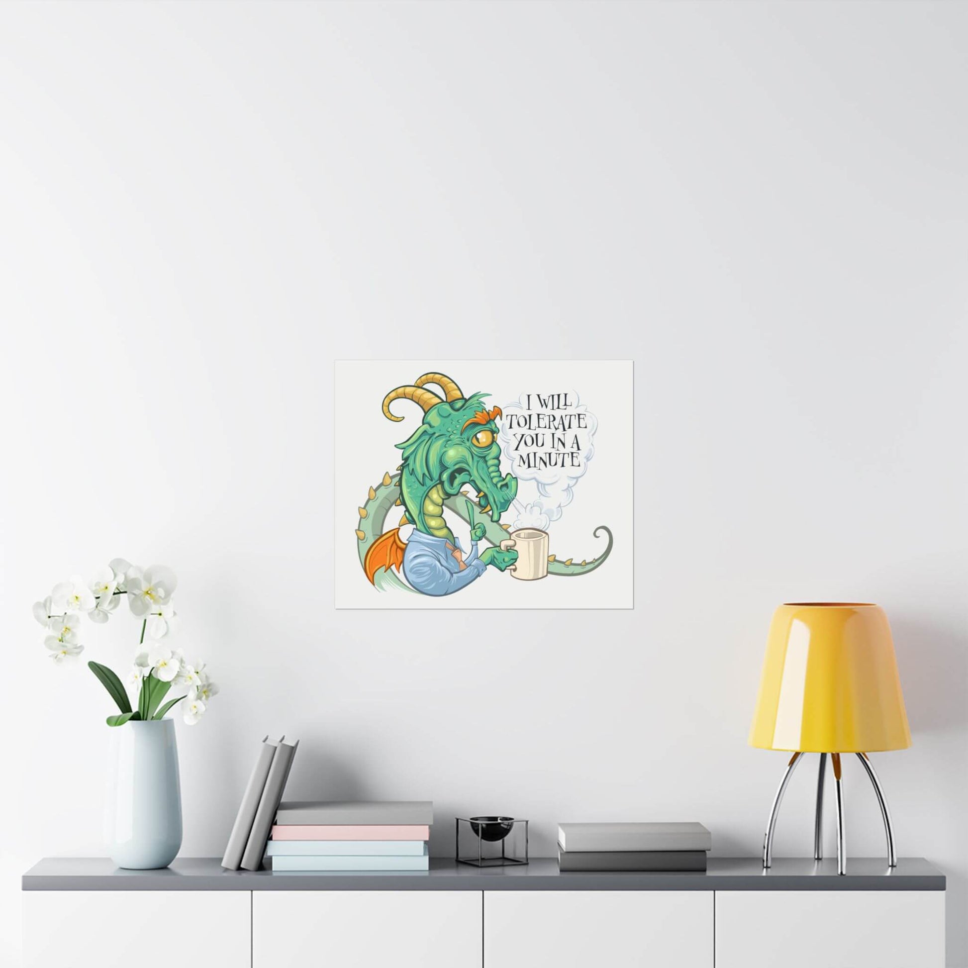 Funny grumpy coffee dragon poster shown on a wall: a horned dragon grumbling over a mug, 'I Will Tolerate You in a Minute'.