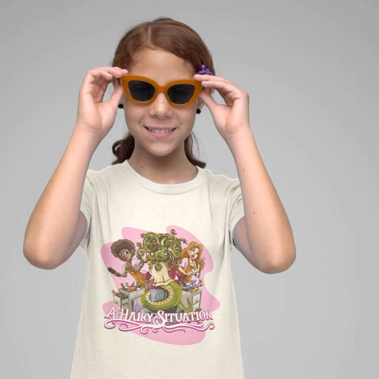 Girl wearing a cartoon tee with the design Medus's Hairy Situation showing the funny cartoon
